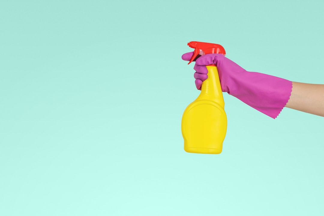 person-holding-yellow-plastic-spray-bottle-zmnefoi3k